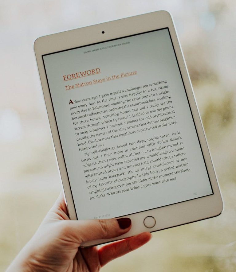 photo of person s hand holding ipad